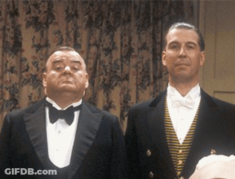 Two Men In Tuxedos Stand Next To Each Other GIF