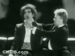 Two Men In Tuxedos Talking GIF