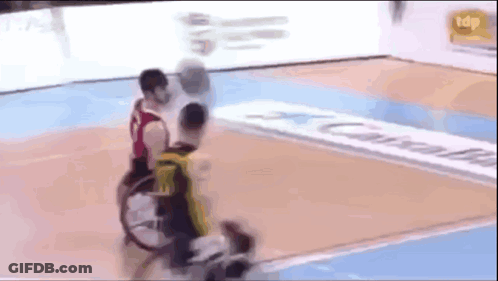 Two Men In Wheelchairs Playing Basketball GIF