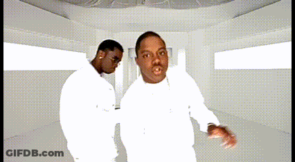 Two Men In White Shirts Are Dancing Together In A White Room GIF