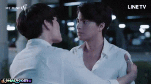 Two Men In White Shirts Hugging In Front Of Line TV Screen GIF
