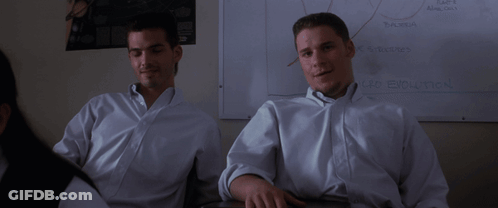Two Men In White Shirts Sit In Front Of A White Board That Says " Car Evolution " GIF
