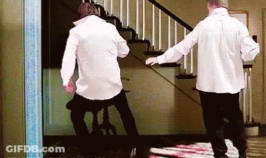 Two Men In White Shirts Walking Down Stairs GIF