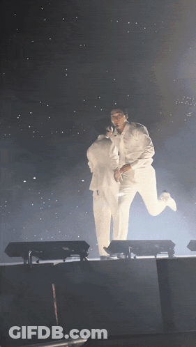 Two Men In White Suits Holding GIF