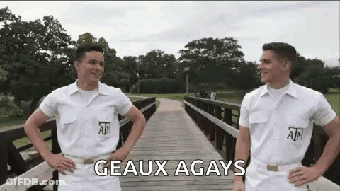 Two Men In White Uniforms Standing On A Bridge GIF