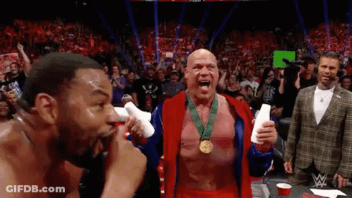 Two Men In Wrestling Ring One Wearing Medal GIF