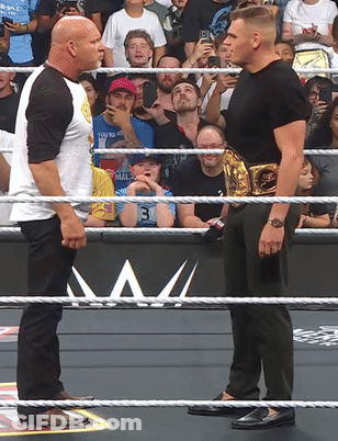Two Men In Wrestling Ring One With Gold Belt GIF