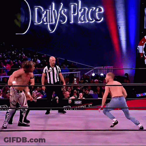 Two Men In Wrestling Ring With Daily's Place Sign GIF