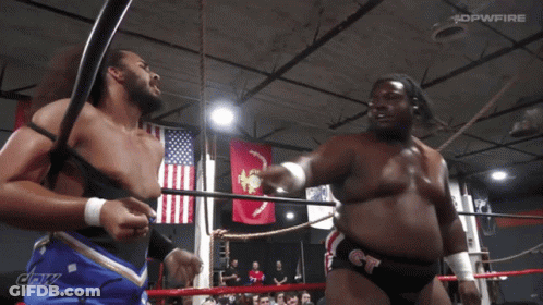 Two Men In Wrestling Ring With DPWFire Banner GIF
