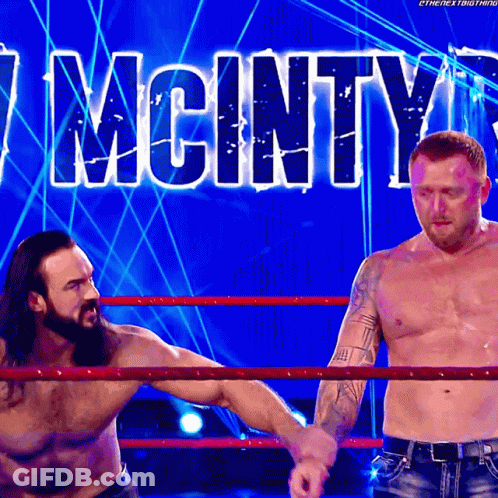 Two Men In Wrestling Ring With Mcinty GIF