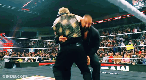 Two Men In Wrestling Ring With Rams On Wall GIF