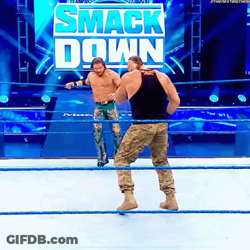 Two Men In Wrestling Ring With Smack Down Sign GIF