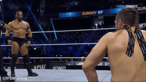 Two Men In Wrestling Ring With Sunday 8P Sign GIF