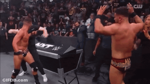 Two Men In Wrestling Trunks GIF