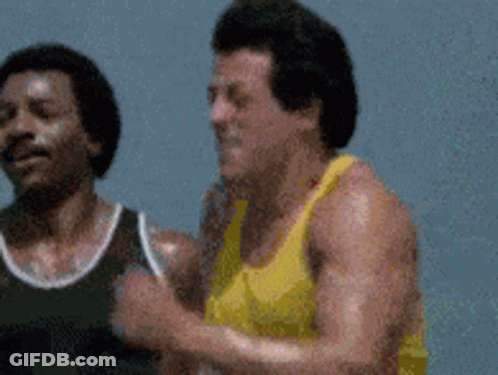 Two Men In Yellow And Black Tank Tops Running GIF