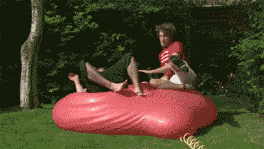 Two Men Jump On Water Balloon GIF