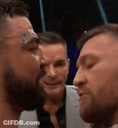 Two Men Kissing In Crowd GIF