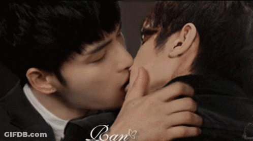 Two Men Kissing In Front Of Ran Sign GIF