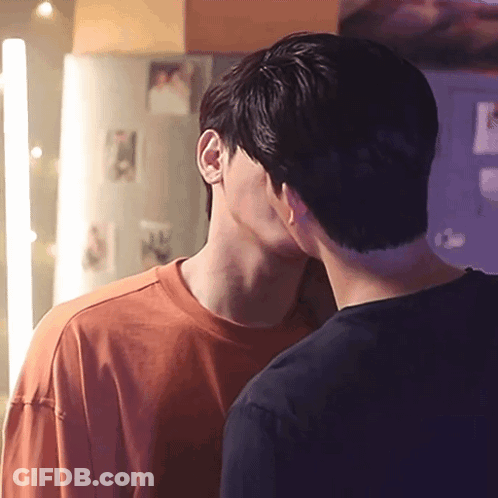 Two Men Kissing In Front Of Refrigerator GIF