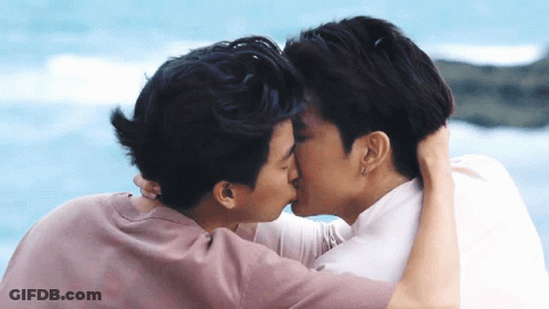 Two Men Kissing In Front Of Water GIF