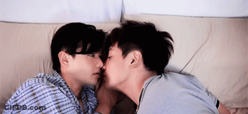 Two Men Kissing On Bed GIF