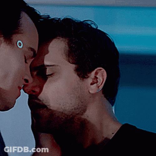 Two Men Kissing With Circle On Forehead GIF