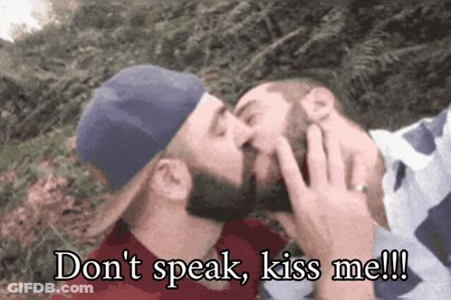 Two Men Kissing With The Words " Do N't Speak Kiss Me " Written Below Them GIF