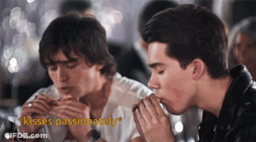 Two Men Kissing With The Words Kisses Passionately In The Corner GIF