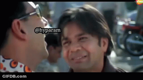 Two Men Laughing And Looking At Each Other GIF