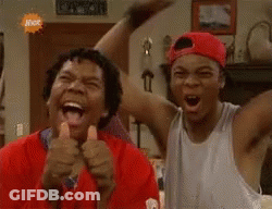 Two Men Laughing And Thumbs Up In Living Room GIF