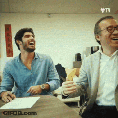 Two Men Laughing At Table GIF
