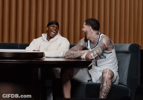 Two Men Laughing At Table One With LS Jersey GIF