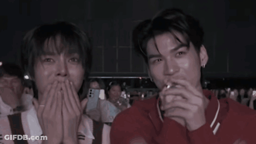 Two Men Laughing In Crowd GIF