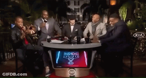 Two Men Laughing In Front Of Kia Banner GIF