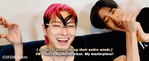 Two Men Laughing On Couch With Pink And Black Hair GIF