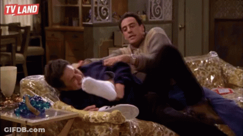 Two Men Laying On A Couch With TV Land Written On The Bottom Left GIF
