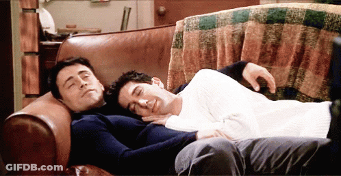 Two Men Laying On Couch Heads Together GIF