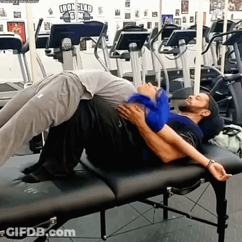Two Men Laying On Gym Bench With Iron Clad Sign GIF