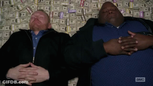 Two Men Laying On Money Pile With A And MC GIF