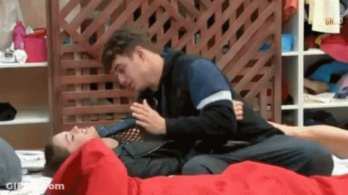Two Men Laying On Top Of Each Other On Bed With Wooden Fence GIF