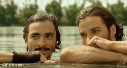 Two Men Leaning Over Water Looking At Each Other GIF