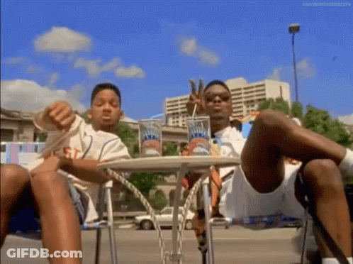 Two Men Legs Crossed Drinking Soda GIF
