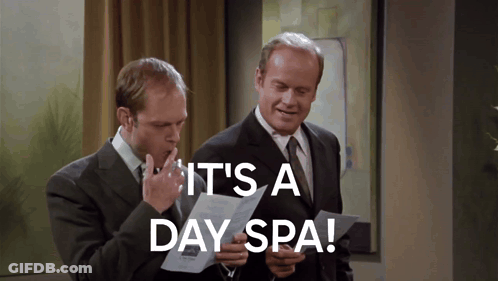 Two Men Looking At A Piece Of Paper With The Words It 'S A Day Spa On It GIF