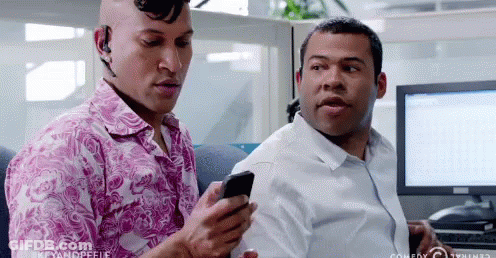 Two Men Looking At Cell Phone In Office GIF