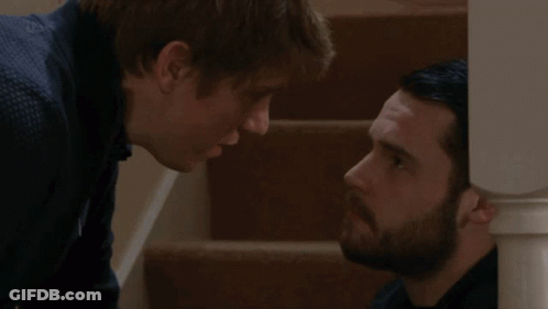 Two Men Looking At Each Other GIF