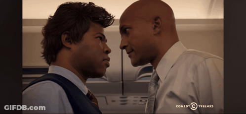 Two Men Looking At Each Other Comedy Central Logo GIF