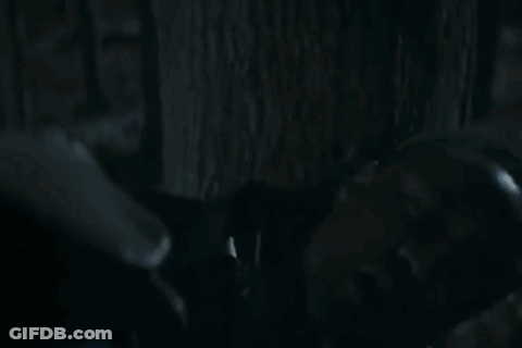 Two Men Looking At Each Other In Dark Room GIF