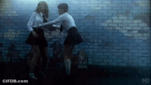 Two Men Looking At Each Other In The Dark GIF