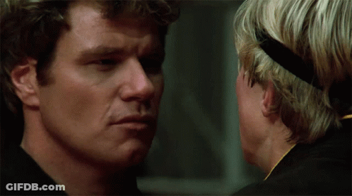 Two Men Looking At Each Other One With Headband GIF