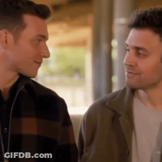 Two Men Looking At Each Other Smiling GIF
